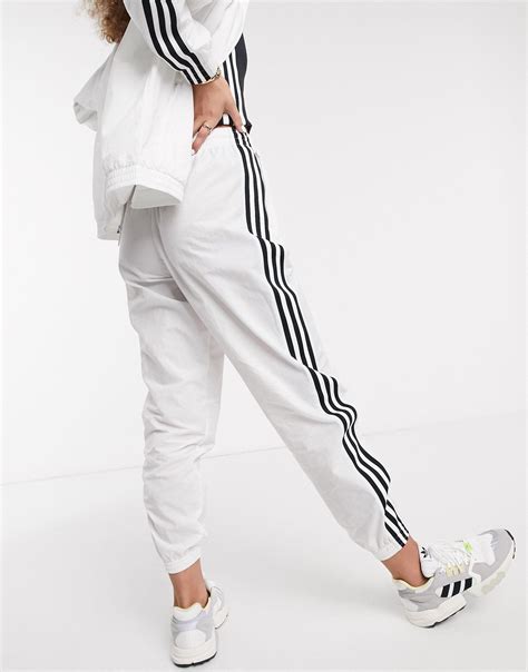 adidas Originals adicolor locked up logo track pants in white 